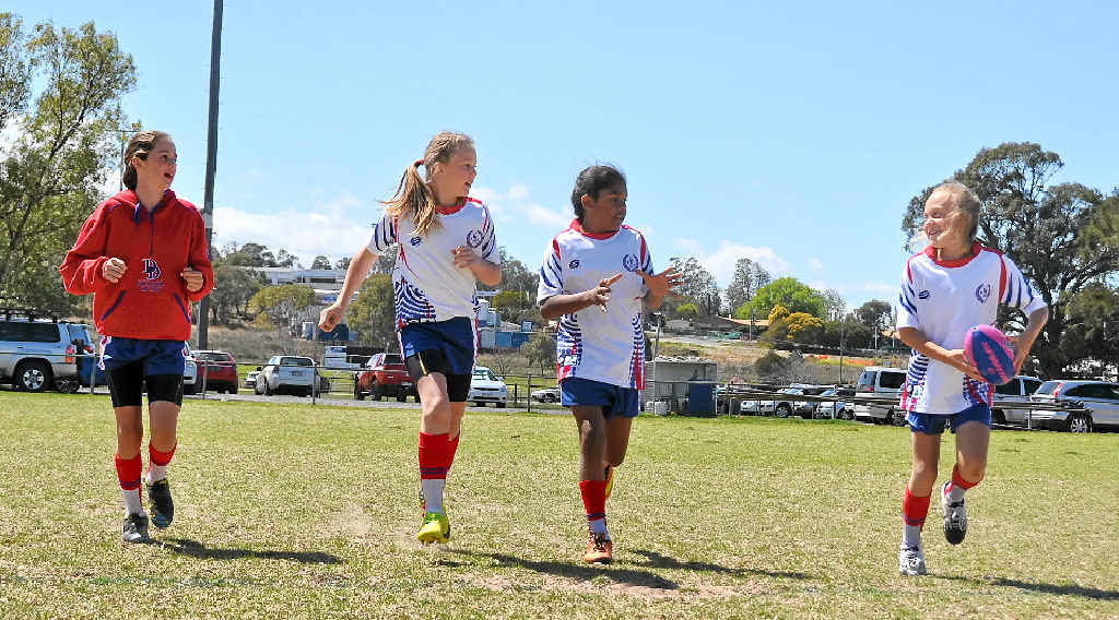 GIRLS’ GAME TOO: Darling Downs Reds player Indiah Loy from Texas trains with White team players Ellee Bowen (Goondiwindi), Elouise Close-Bond and Kira Etherington (both Warwick Central) at the Queensland 12 years and under Girls Rugby League Carnival yesterday. GIRLS’ GAME TOO: Darling Downs Reds player Indiah Loy from Texas trains with White team players Ellee Bowen (Goondiwindi), Elouise Close-Bond and Kira Etherington (both Warwick Central) at the Queensland 12 years and under Girls Rugby League Carnival yesterday.